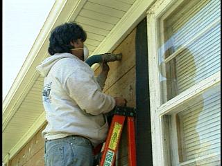 Insulation being retrofitted in the wall of a home.