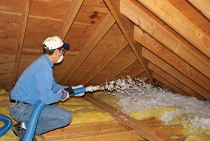 Insulation contractors spraying insulation into an attic in Boise, Idaho.