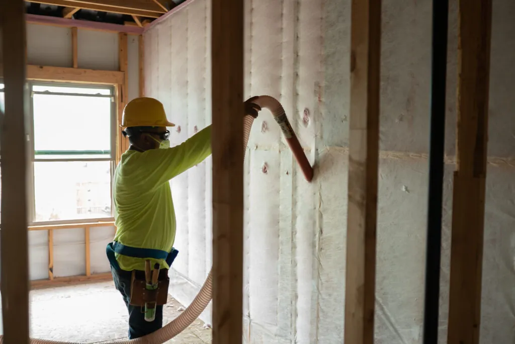 Tech installing insulation